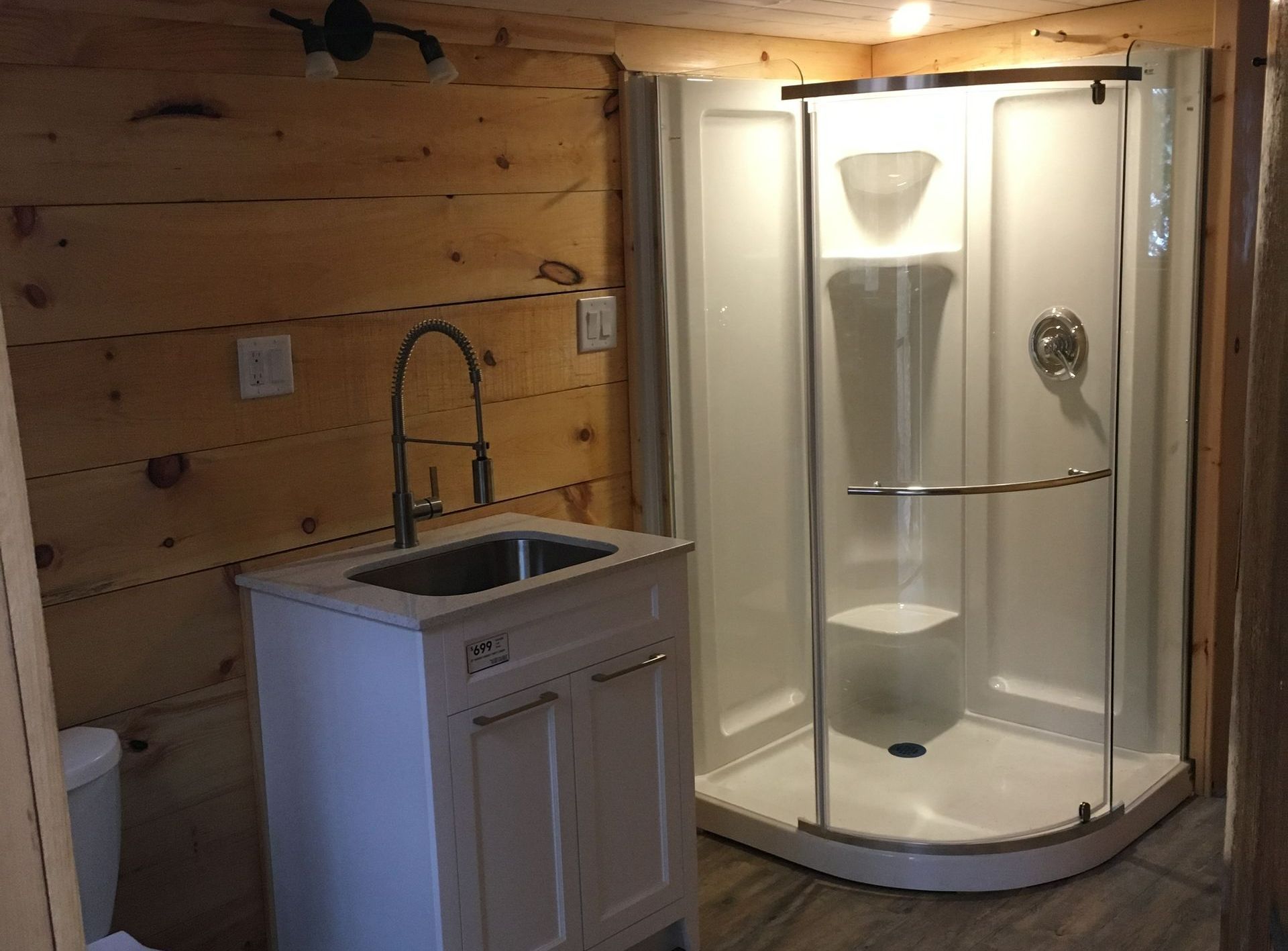 A bathroom with a sink , toilet and shower.