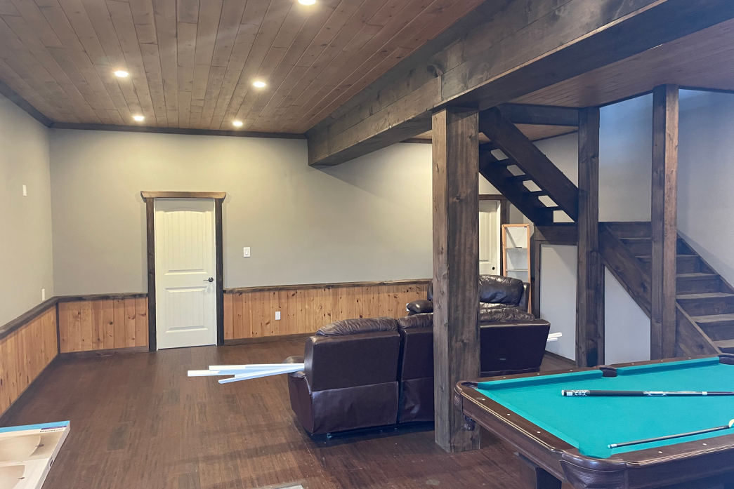 There is a pool table in the middle of the room.