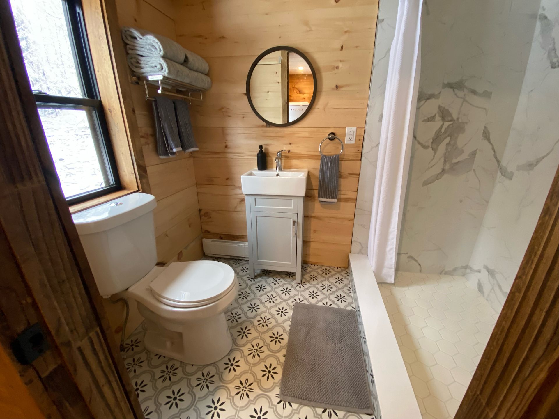 A bathroom with a toilet , sink , and shower.