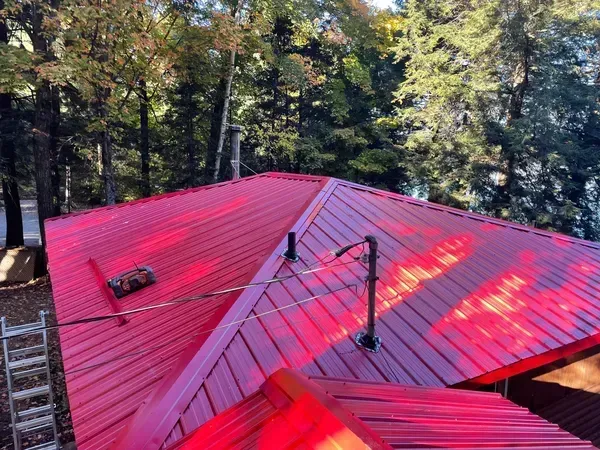 A red roof with a ladder on top of it