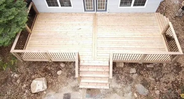 An aerial view of a wooden deck next to a house.