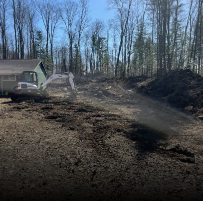 An excavator is moving dirt in front of a house