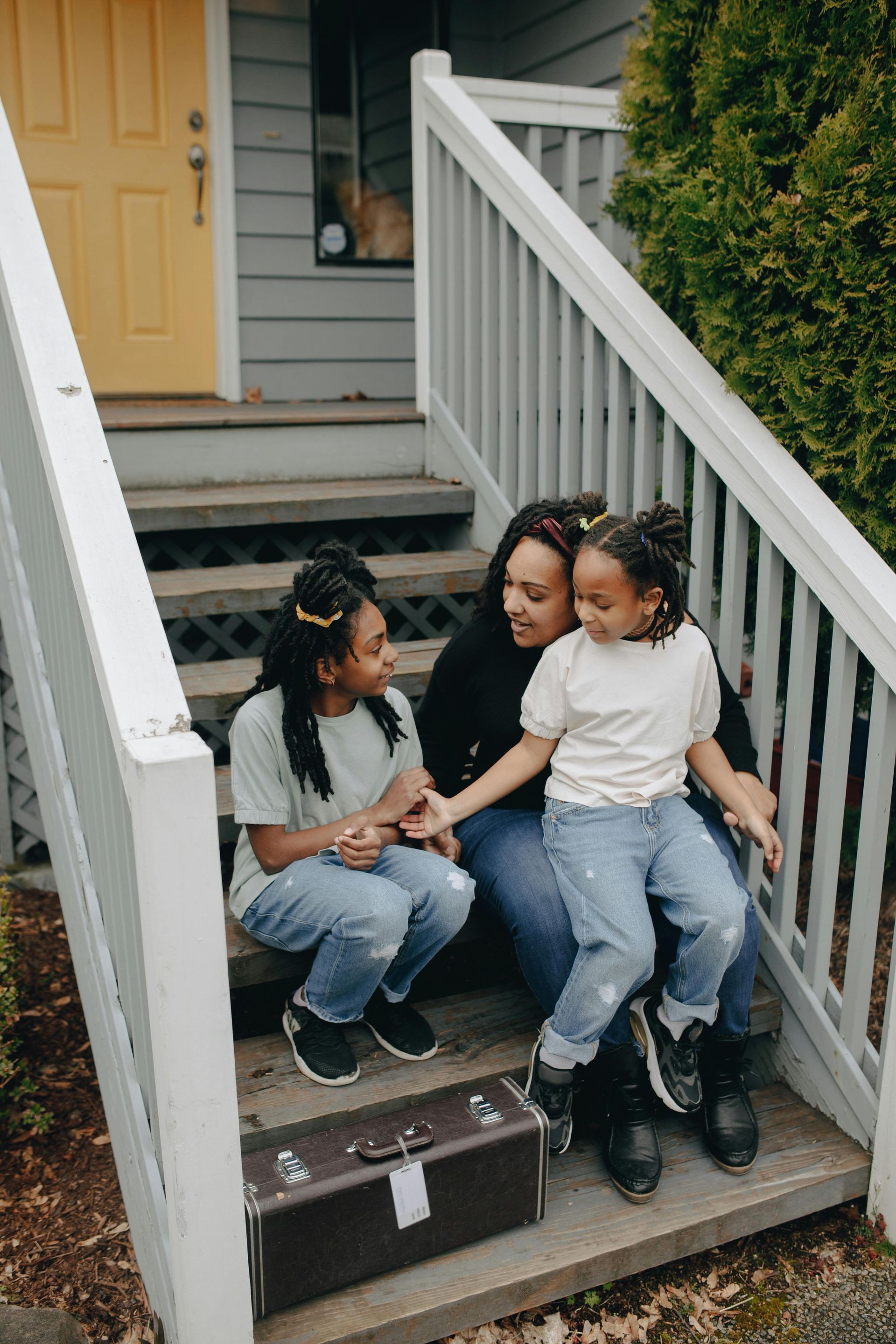 Mom with kids on stairs at rental home