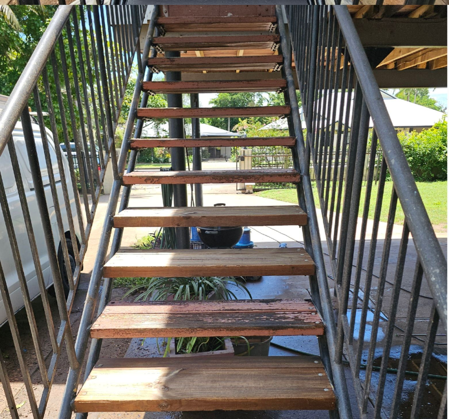 Wooden outdoor staircase with metal railings, leading upwards — Prestige Painting NT in Zuccoli, NT