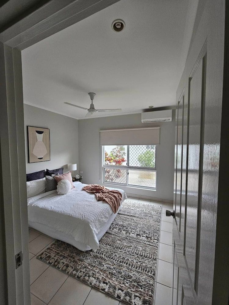 Bedroom Interior With Bed, Rug, Window, and Artwork — Prestige Painting NT in Zuccoli, NT
