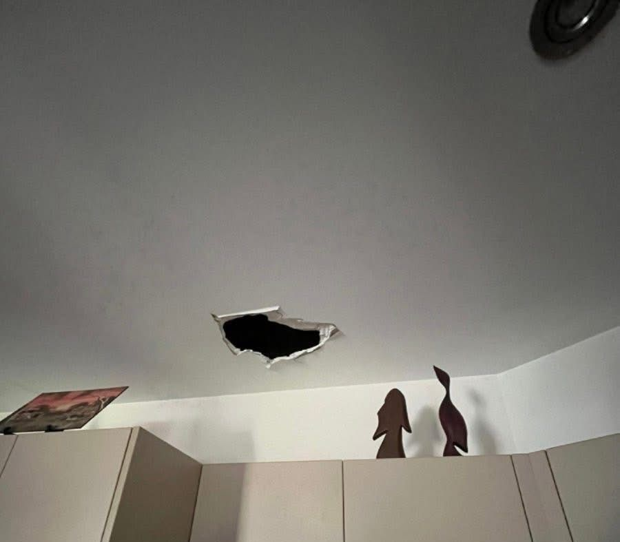 Hole in a white ceiling above a kitchen counter with decorative wooden figures — Prestige Painting NT in Zuccoli, NT