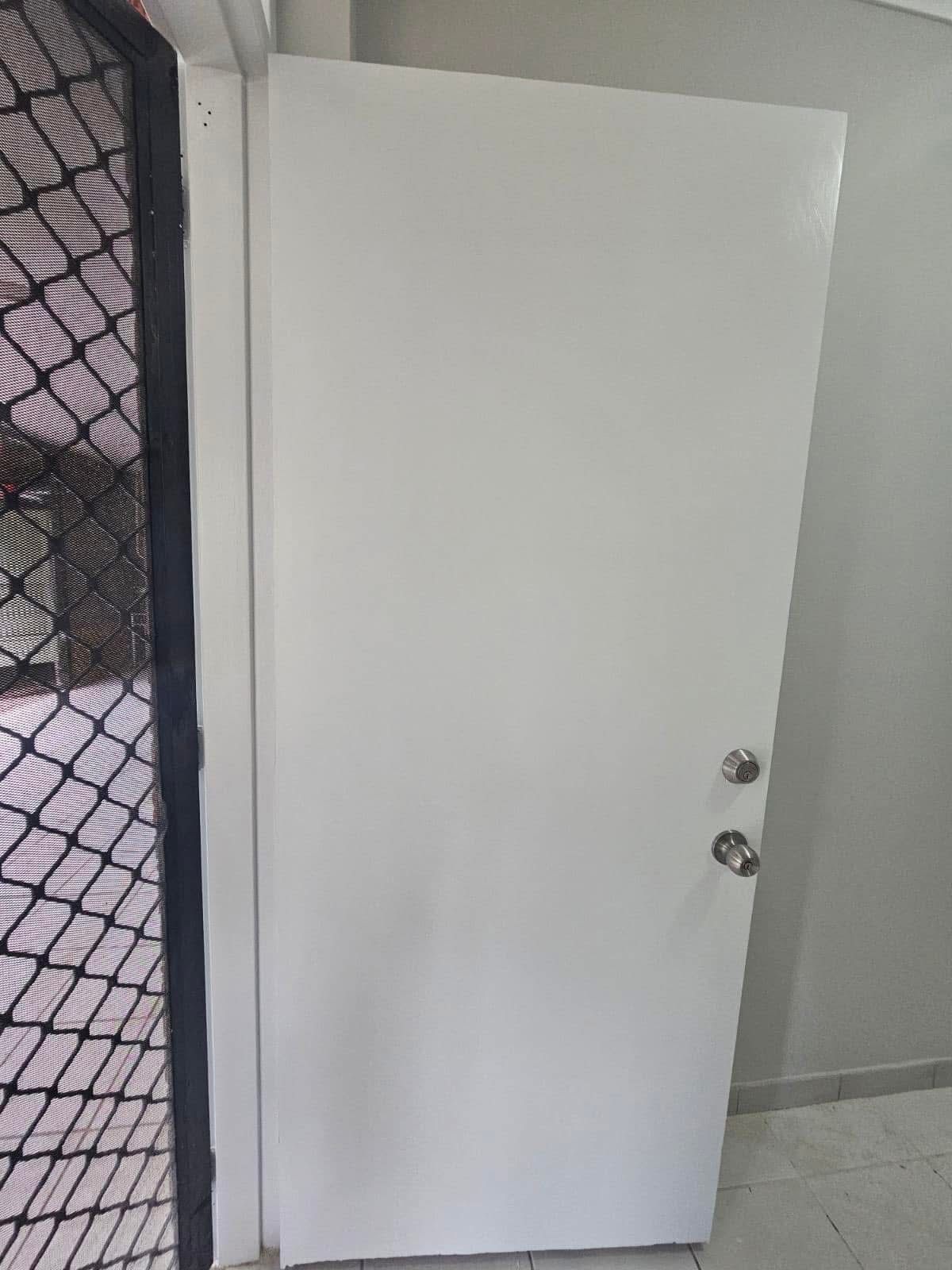 White door with two doorknobs and screen door on the left side — Prestige Painting NT in Zuccoli, NT