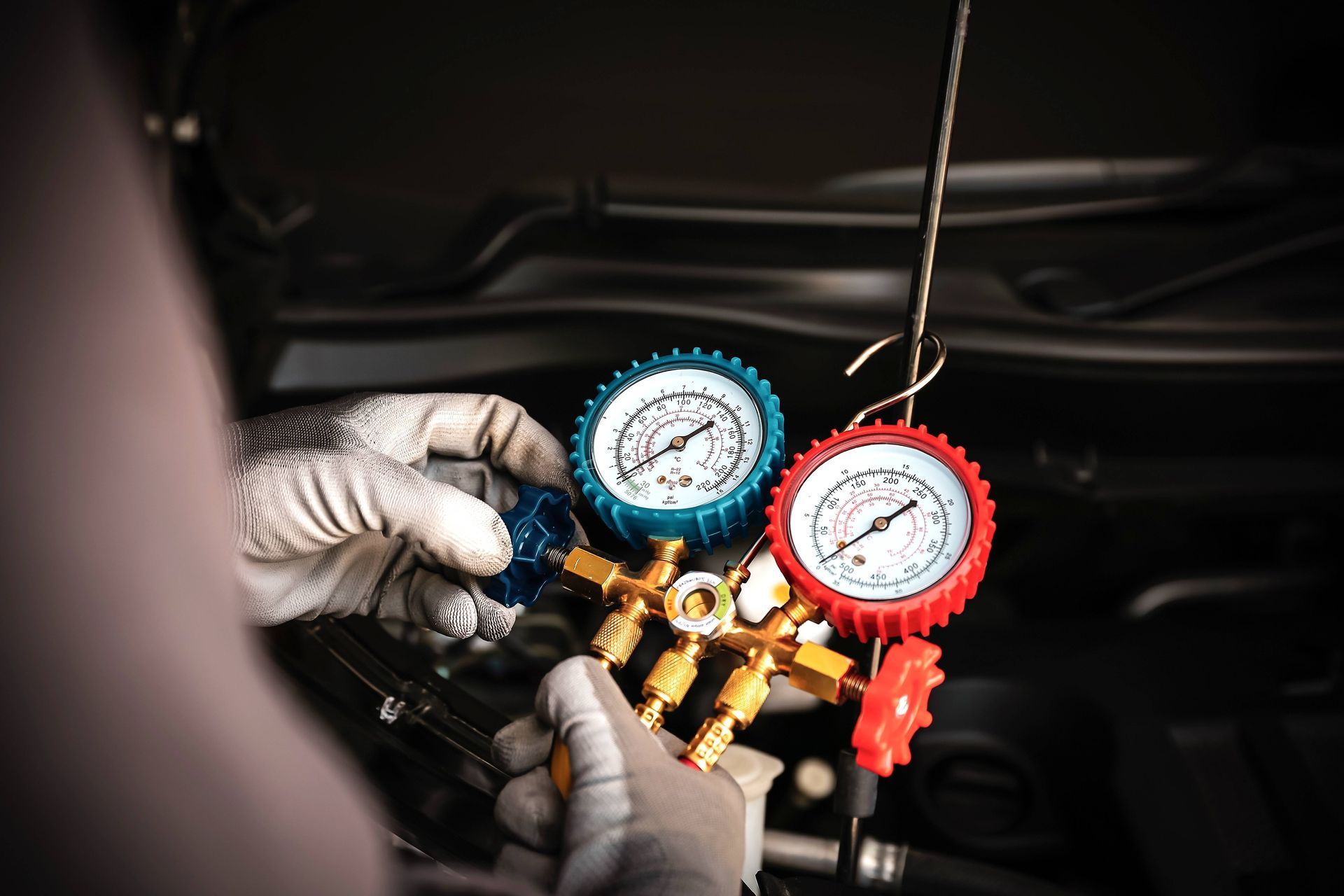a person is working on a gauge that says r134a on it