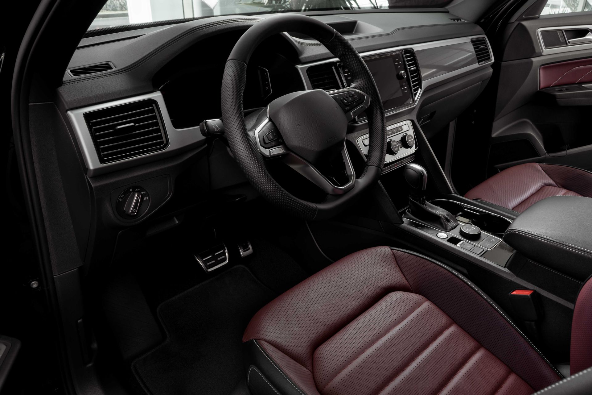 a black car with red seats and a steering wheel