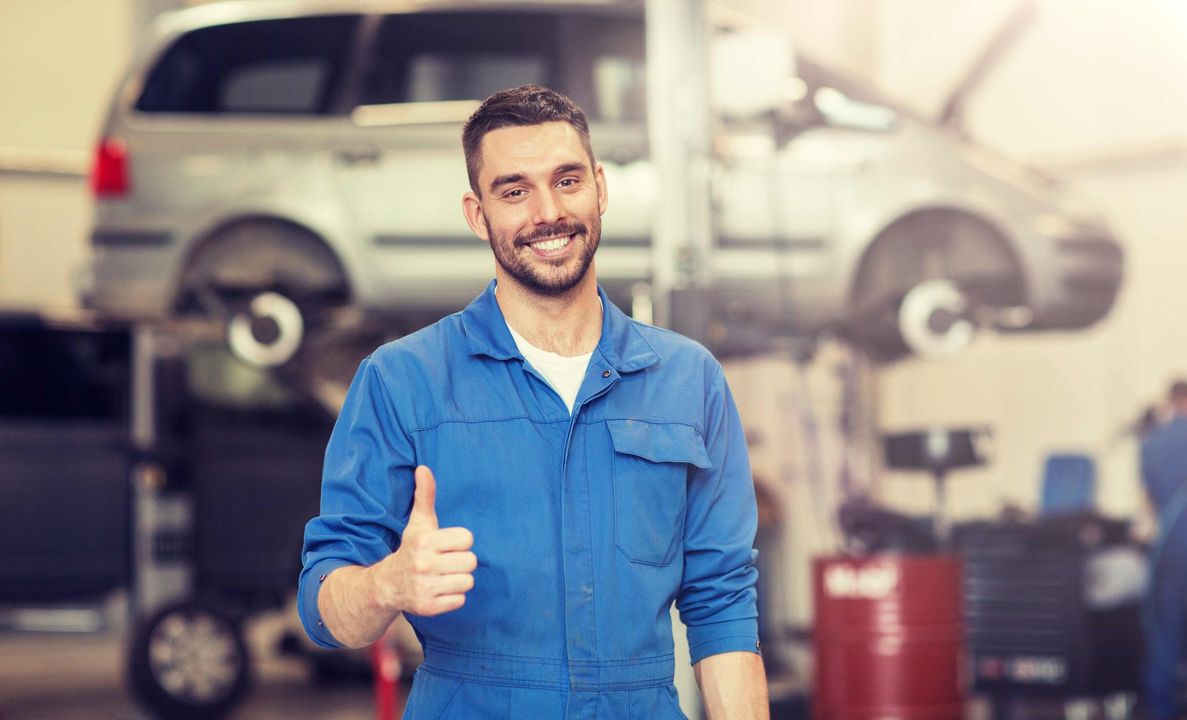 a man in a blue uniform is giving a thumbs up