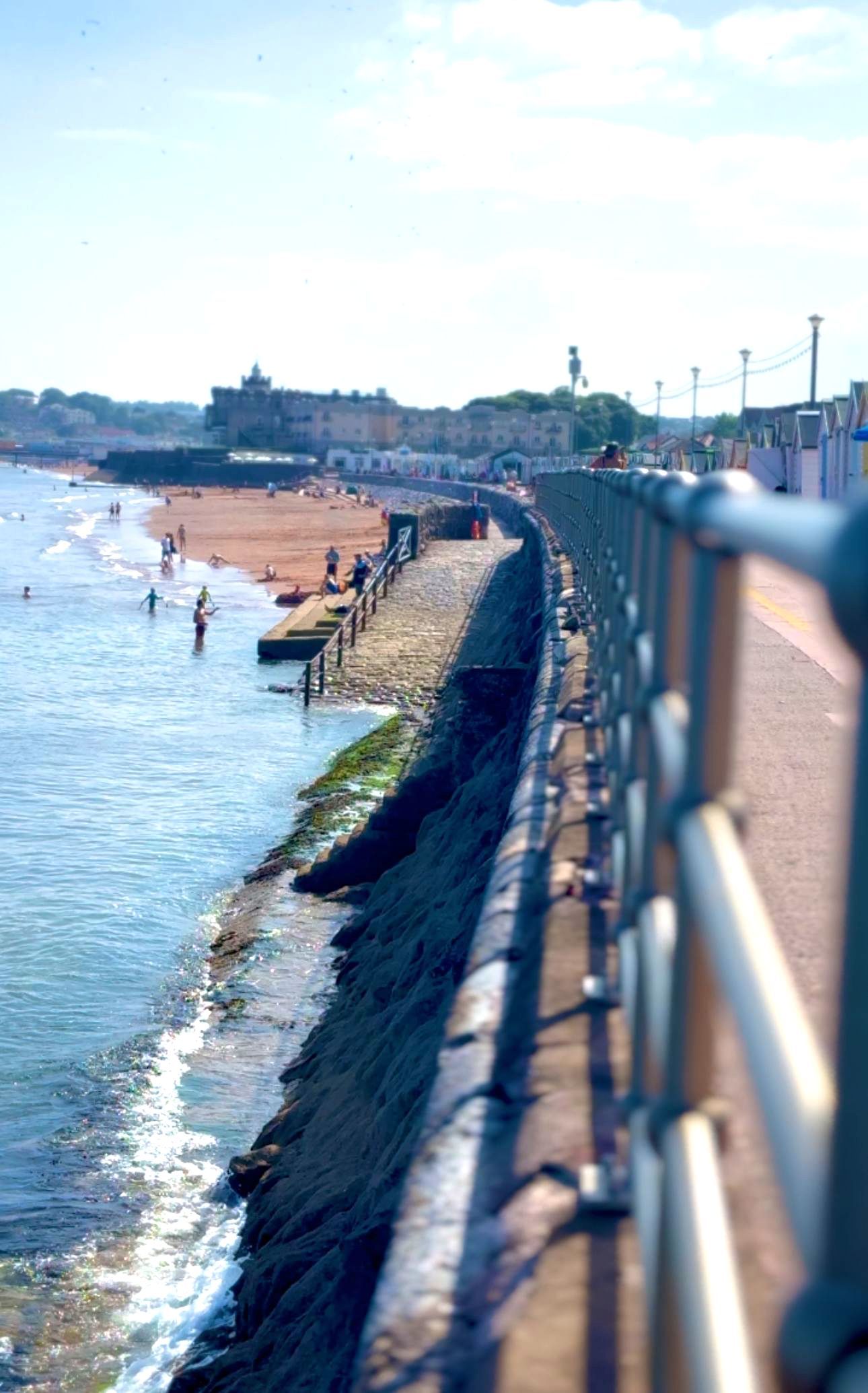 Preston Beach in summer time with sea wall and beach huts, Redcliffe Hotel in background