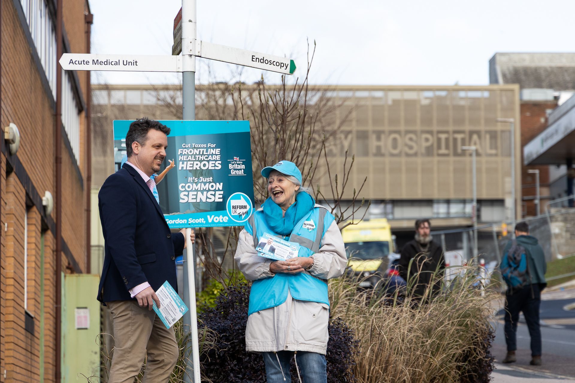 Gordon Scott campaigning with a Reform UK Torbay member outside of the entrance to Torbay Hospital