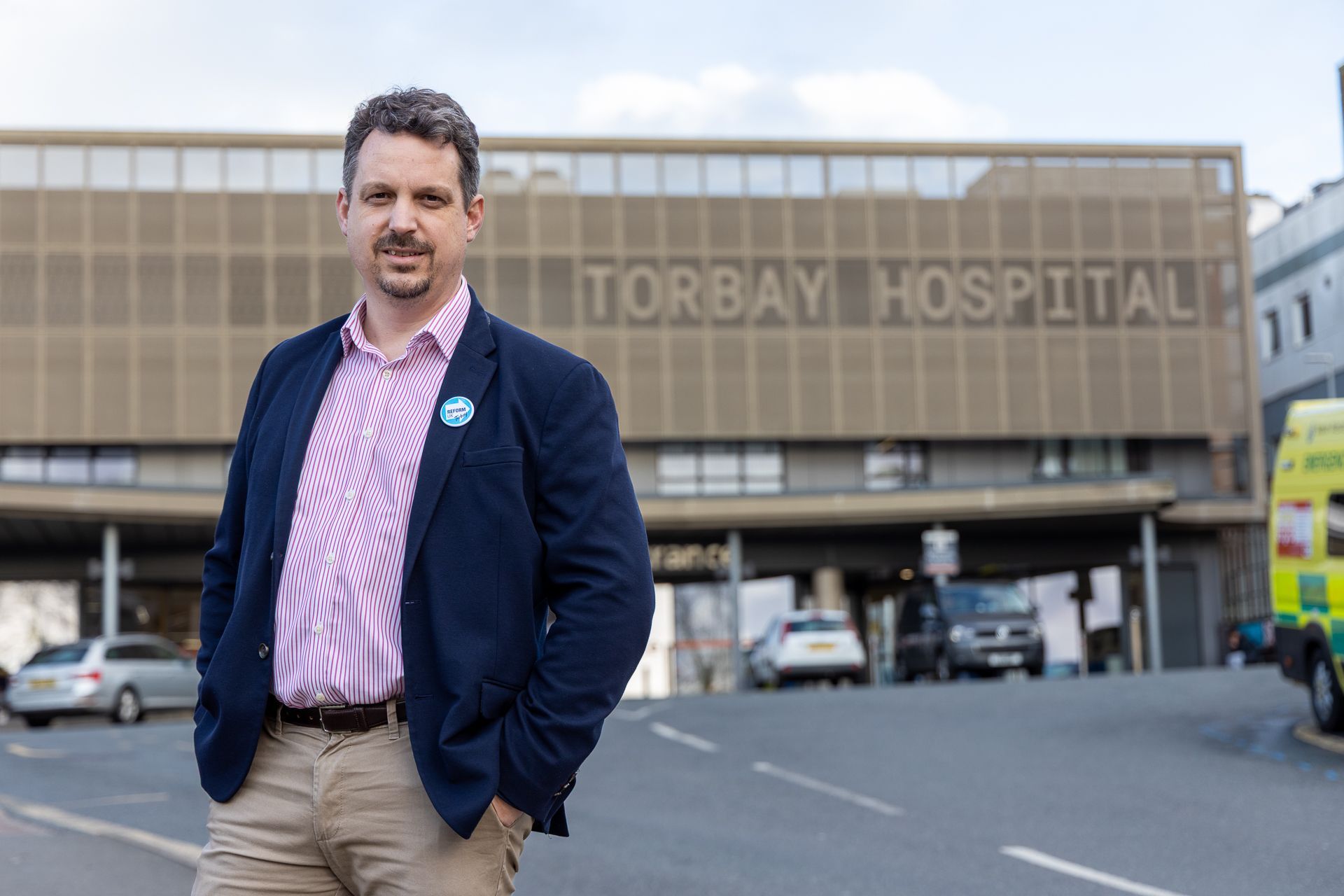 Gordon Scott standing in front of Torbay Hospital entrance