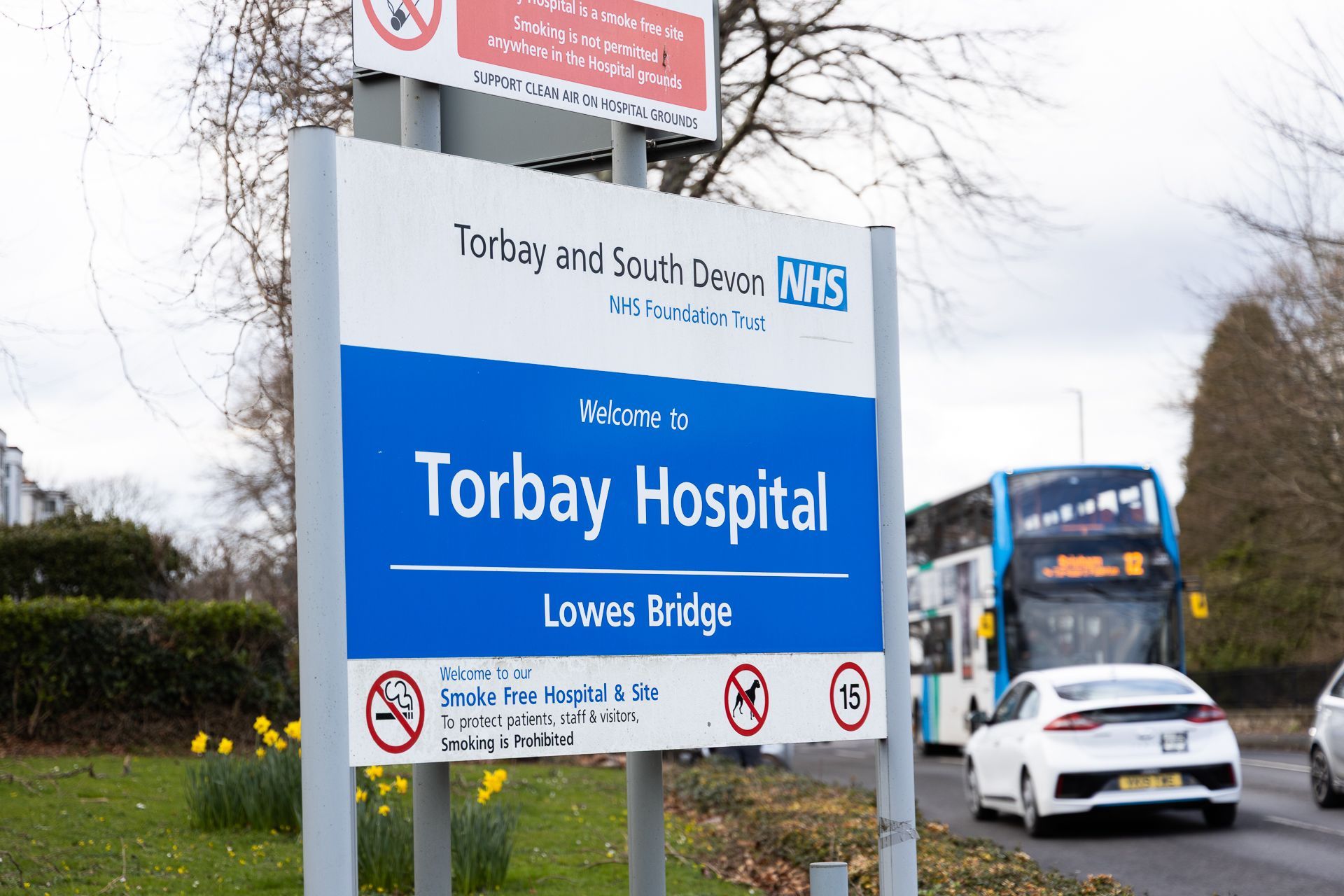 A blue and white sign for the torbay hospital