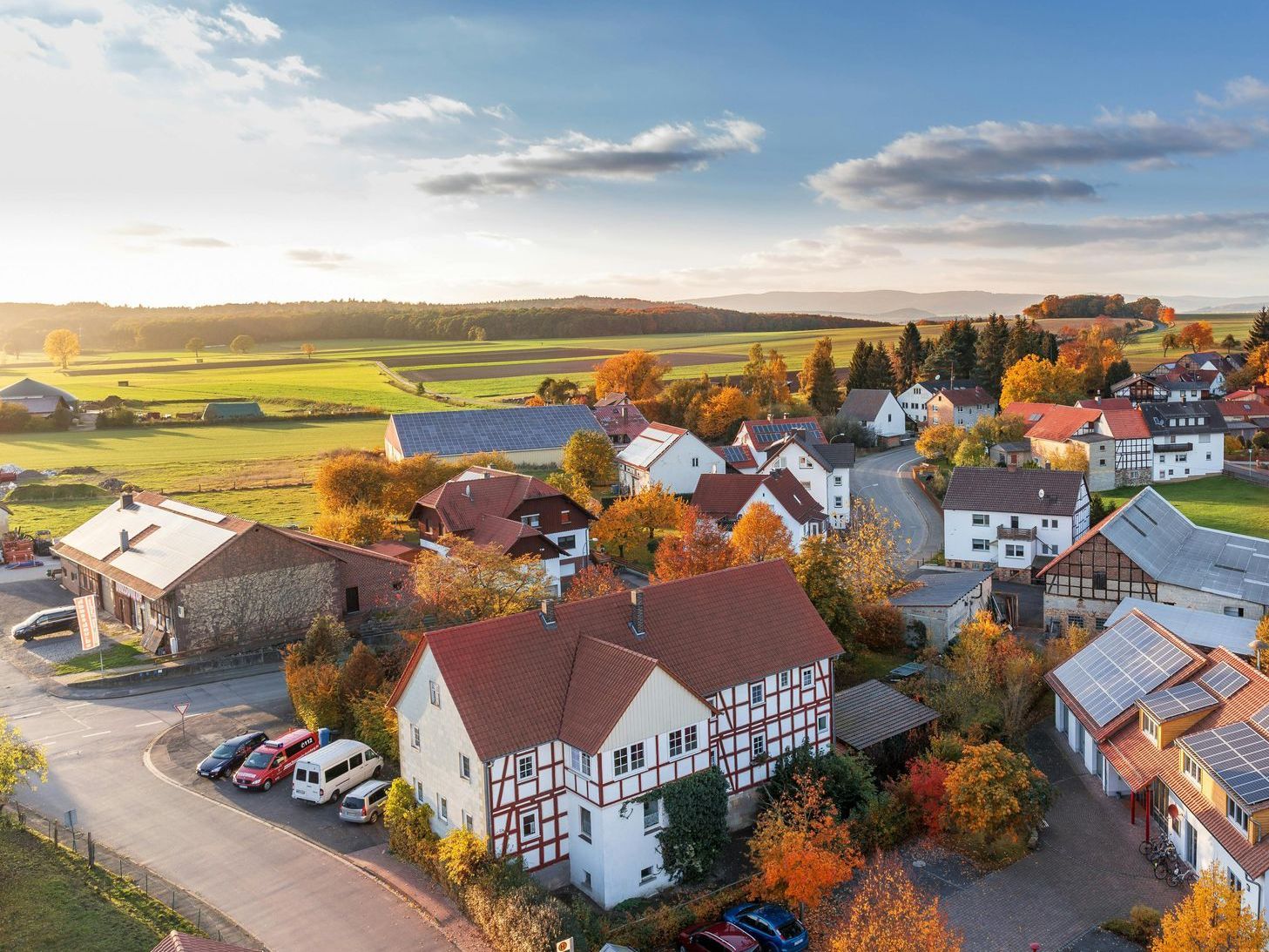 An aerial view of a small village in autumn