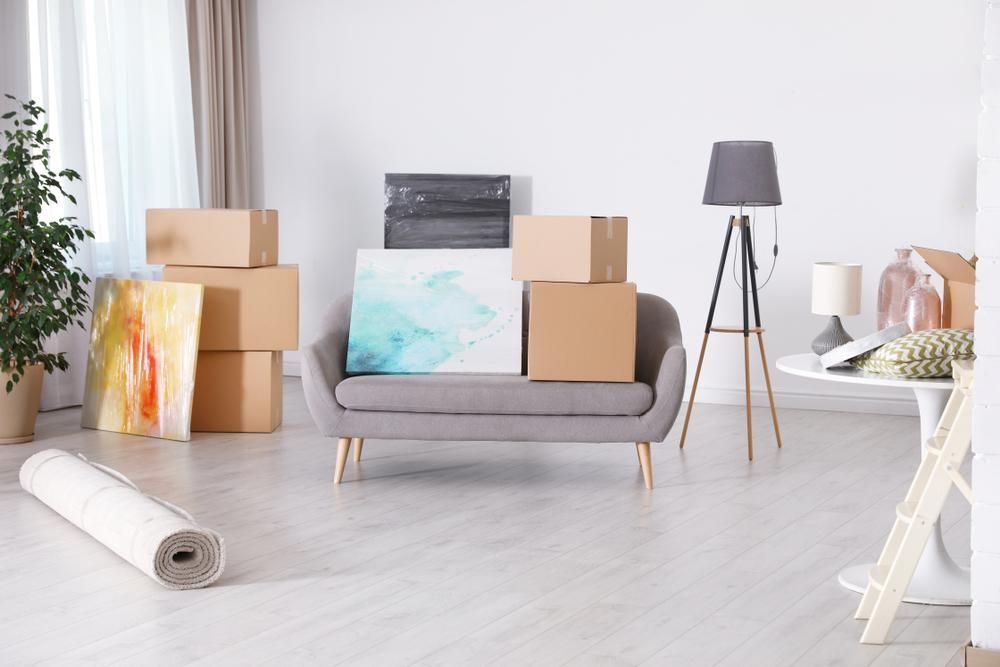 A Living Room Filled With Boxes And A Couch — Brisbane Moving & Storage In Charleville, QLD