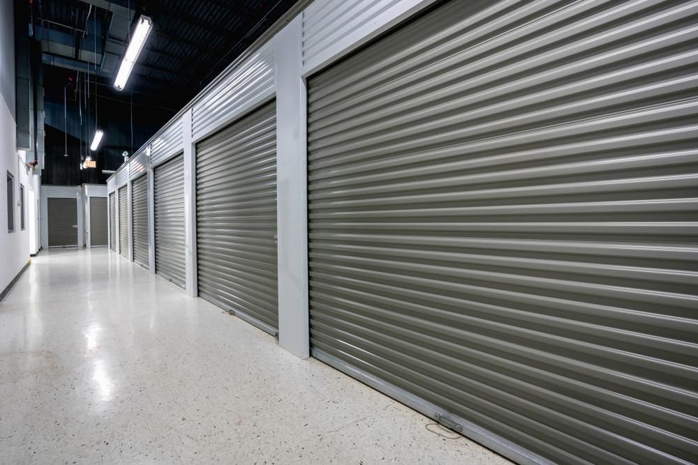 A Hallway With A Row Of Gray Garage Doors — Brisbane Moving & Storage In Acacia Ridge, QLD