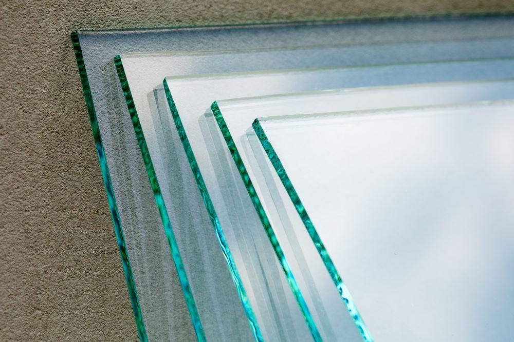 Three Pieces of Glass Are Stacked on Top of Each Other on a Table — Keppel Coast Windscreens in Coorooman, QLD
