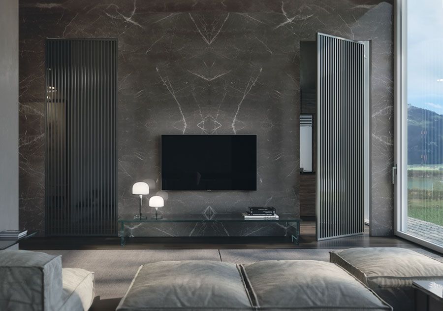 Soggiorno moderno con parete in marmo grigio scuro, grande TV e posti a sedere.
