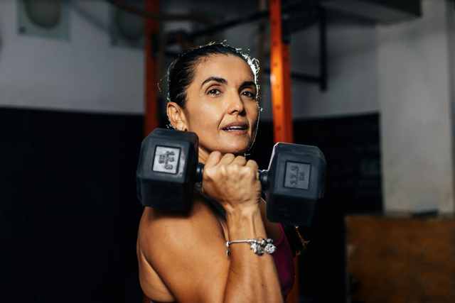 mature woman with a dumb bell at a gym