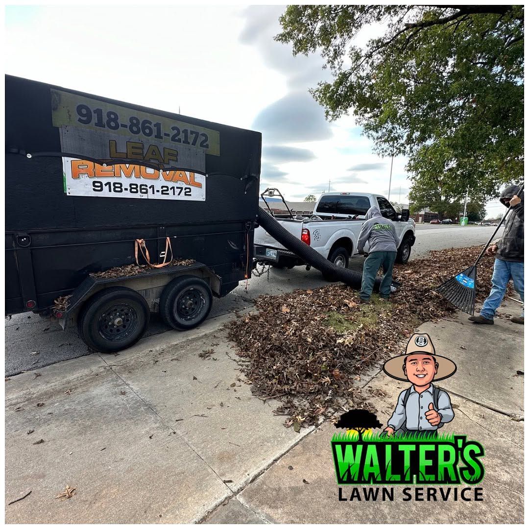 Crew using a vacuum trailer to clear leaves from a white SUV on a residential street