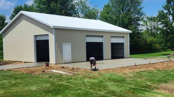 Steel building contractors assemble a large commercial warehouse.