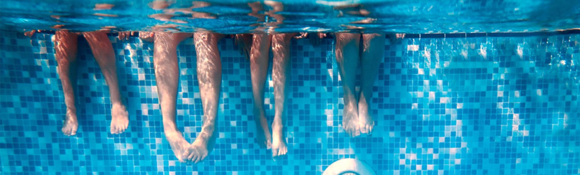 Professional swim instructor teaching a young child