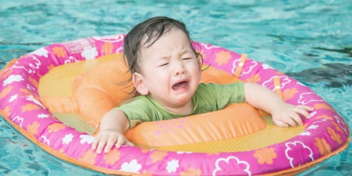 Child playing with toys in pool