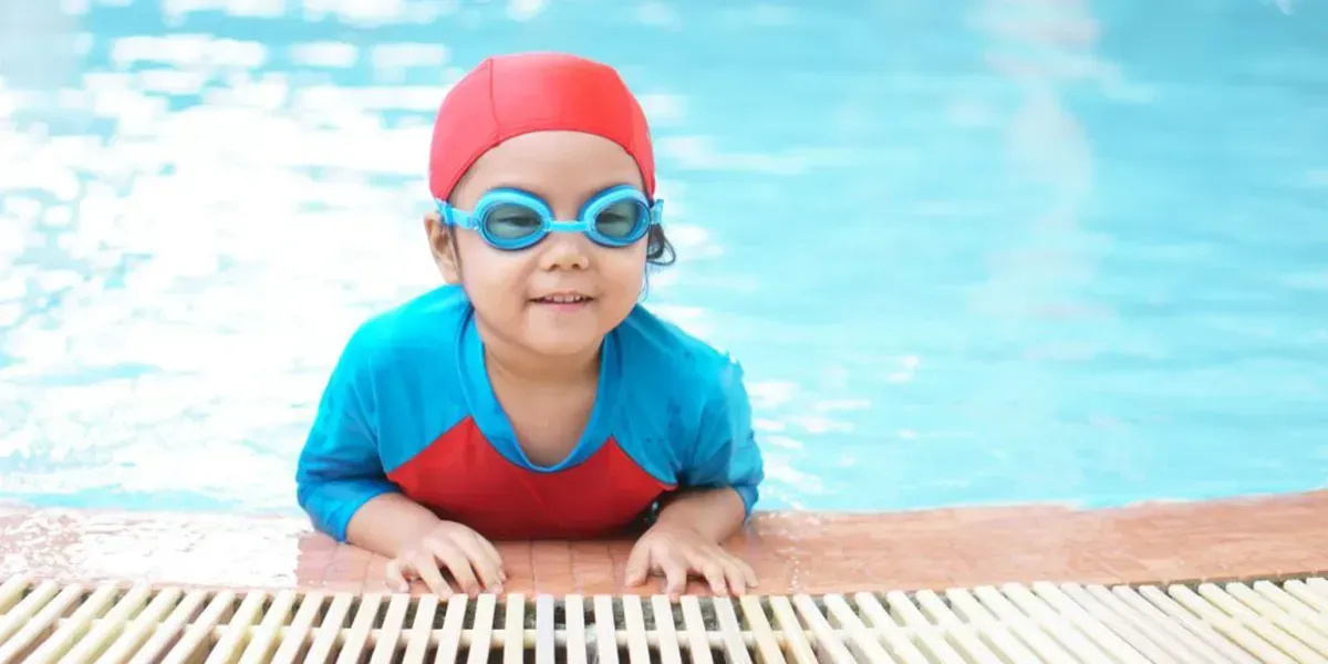 Toddler learning to float with instructor