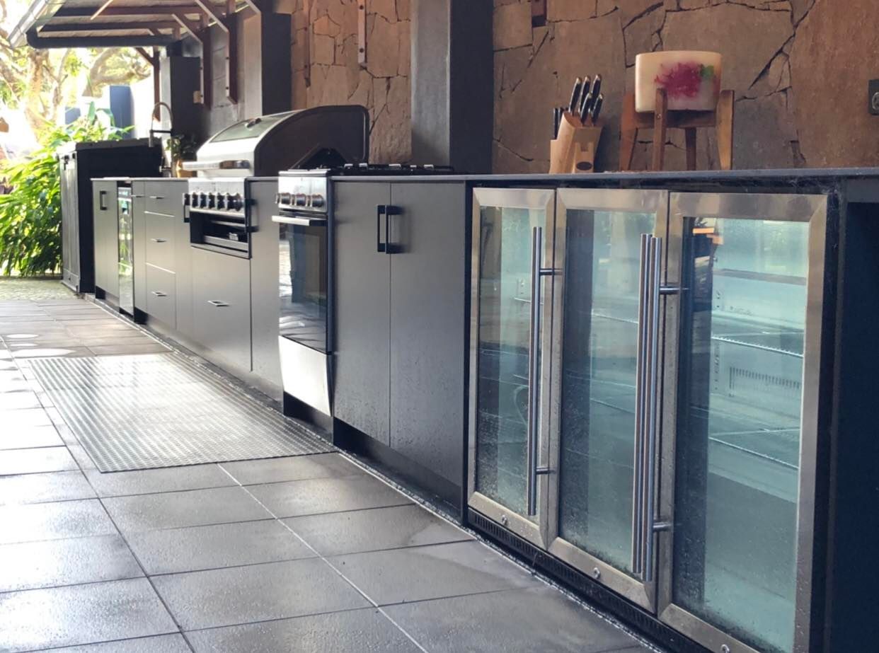 A Kitchen With Stainless Steel Cabinets and Glass Doors — Bali at the Bay in Nelson Bay, NSW