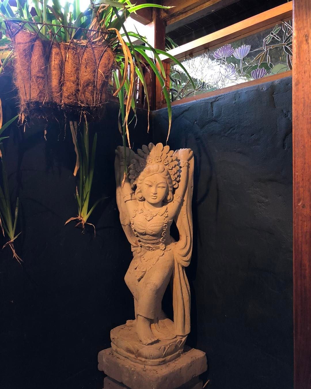 A Statue is Sitting in Front of a Window — Bali at the Bay in Nelson Bay, NSW