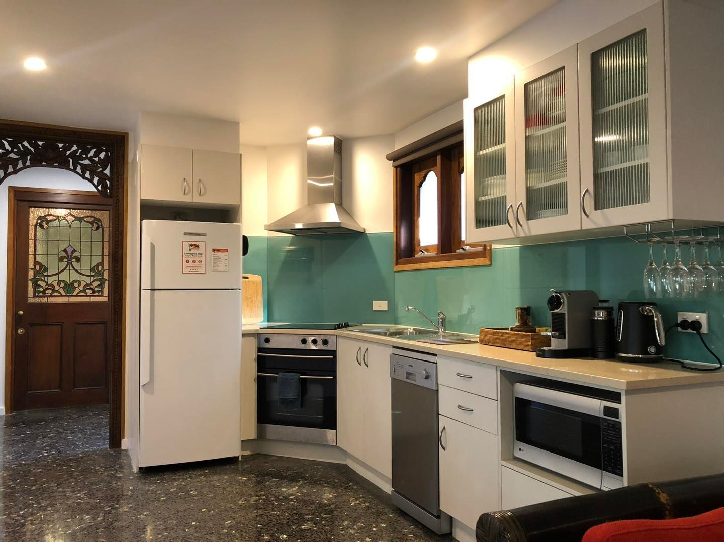 A Kitchen With a Refrigerator and a Microwave — Bali at the Bay in Nelson Bay, NSW