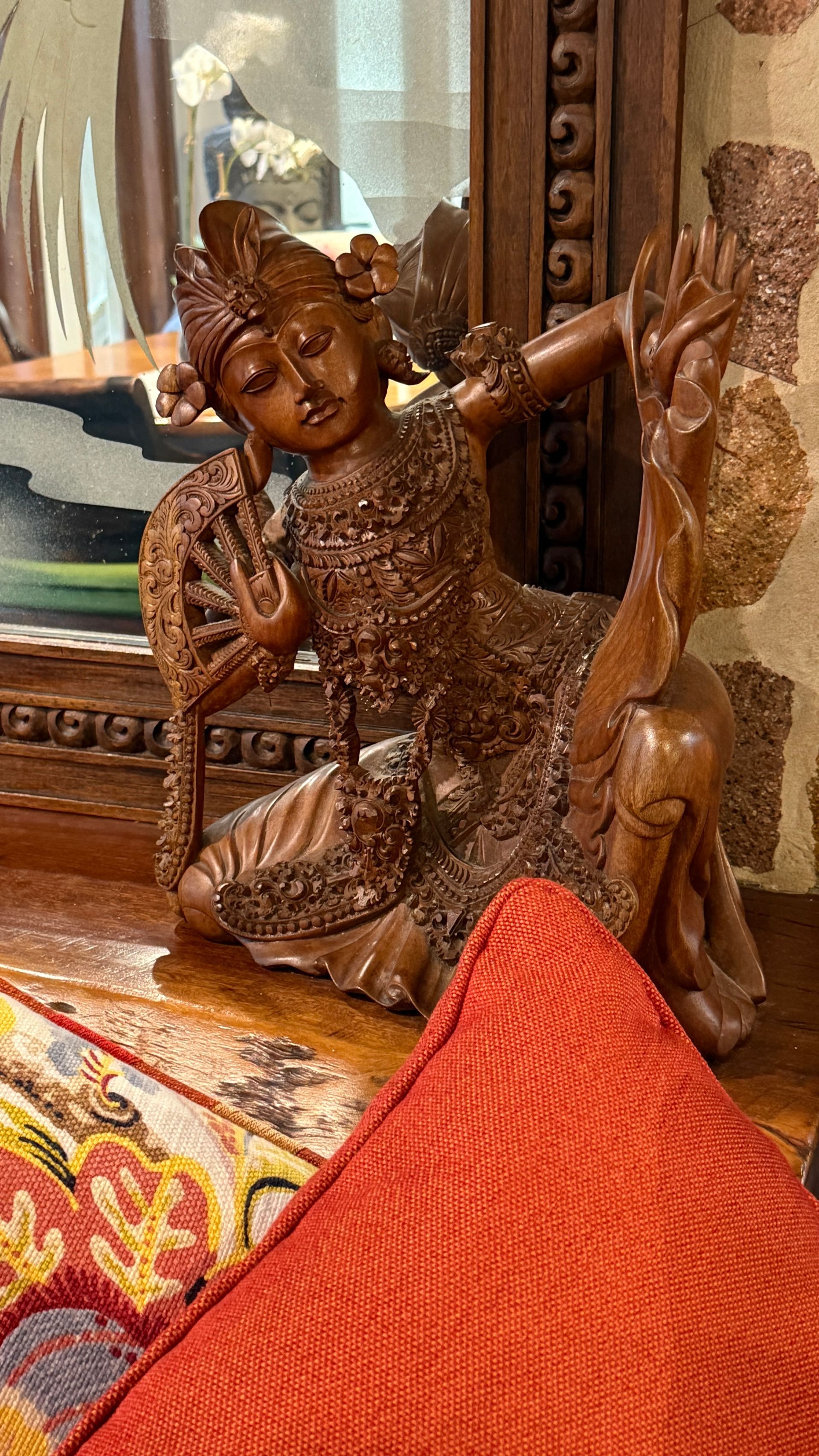 Wooden carving of a woman in traditional garb, relaxed pose — Bali at the Bay in Nelson Bay, NSW