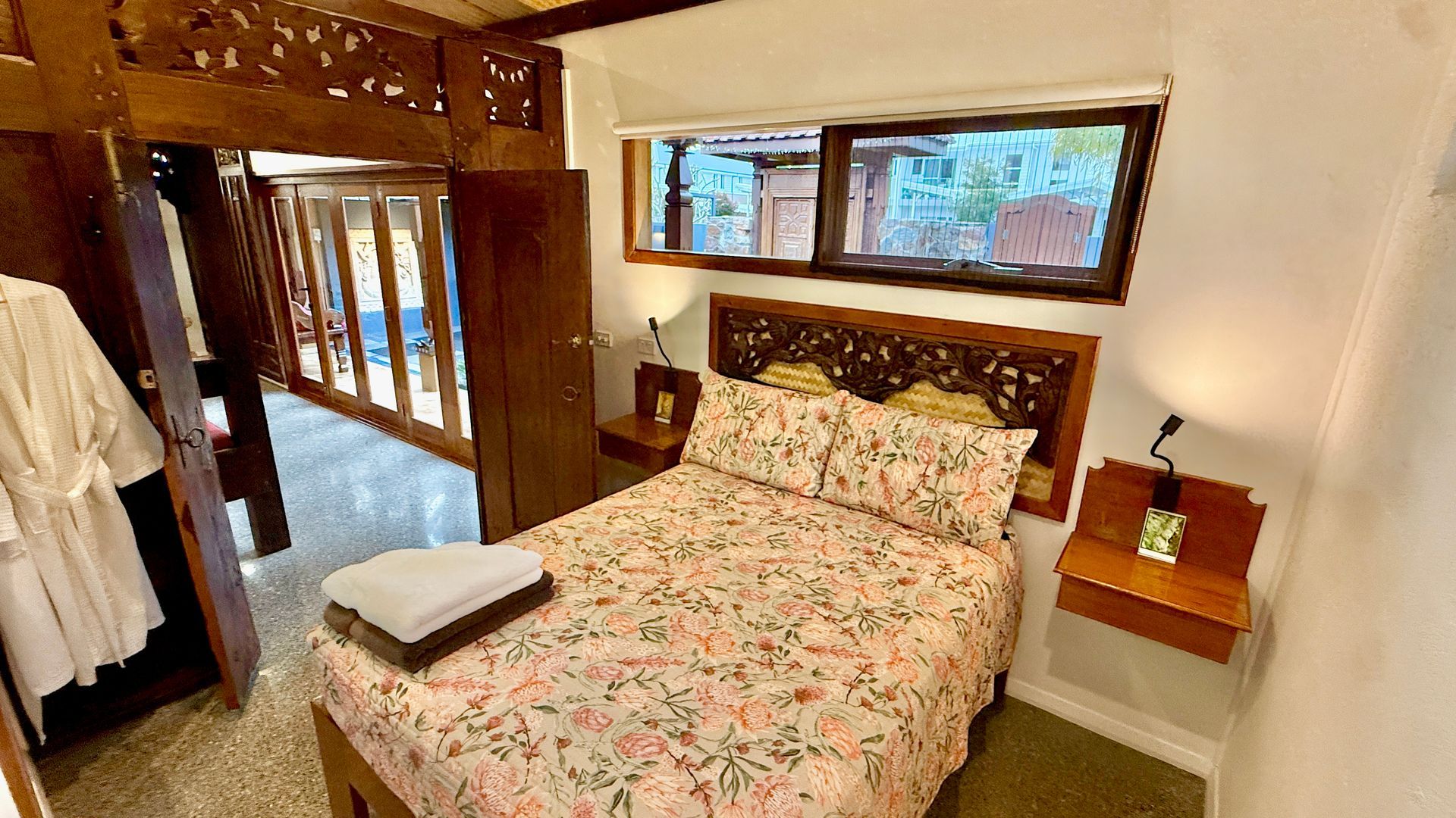 Cozy bedroom with wooden accents and a bed — Bali at the Bay in Nelson Bay, NSW