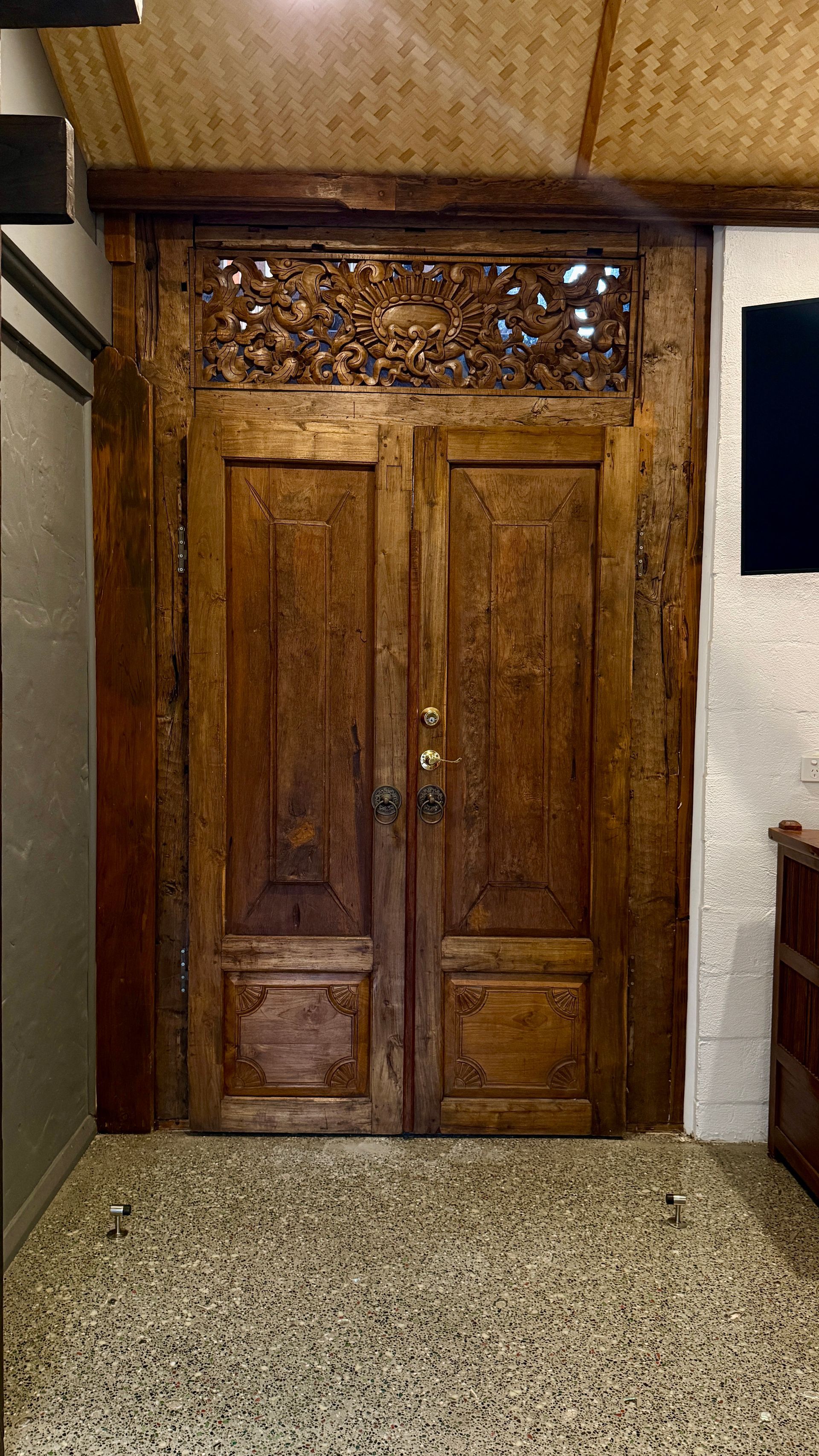 Wooden double doors with ornate carvings — Bali at the Bay in Nelson Bay, NSW