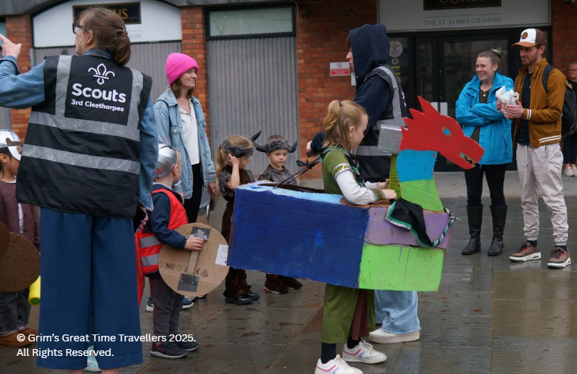 Child has made model longship to join Havelok and march in Grim's Great Viking Parade