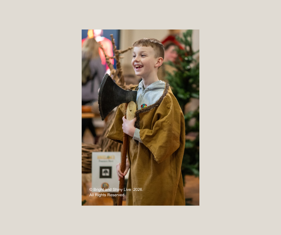 Boy having fun dressing up at Havelok Viking event