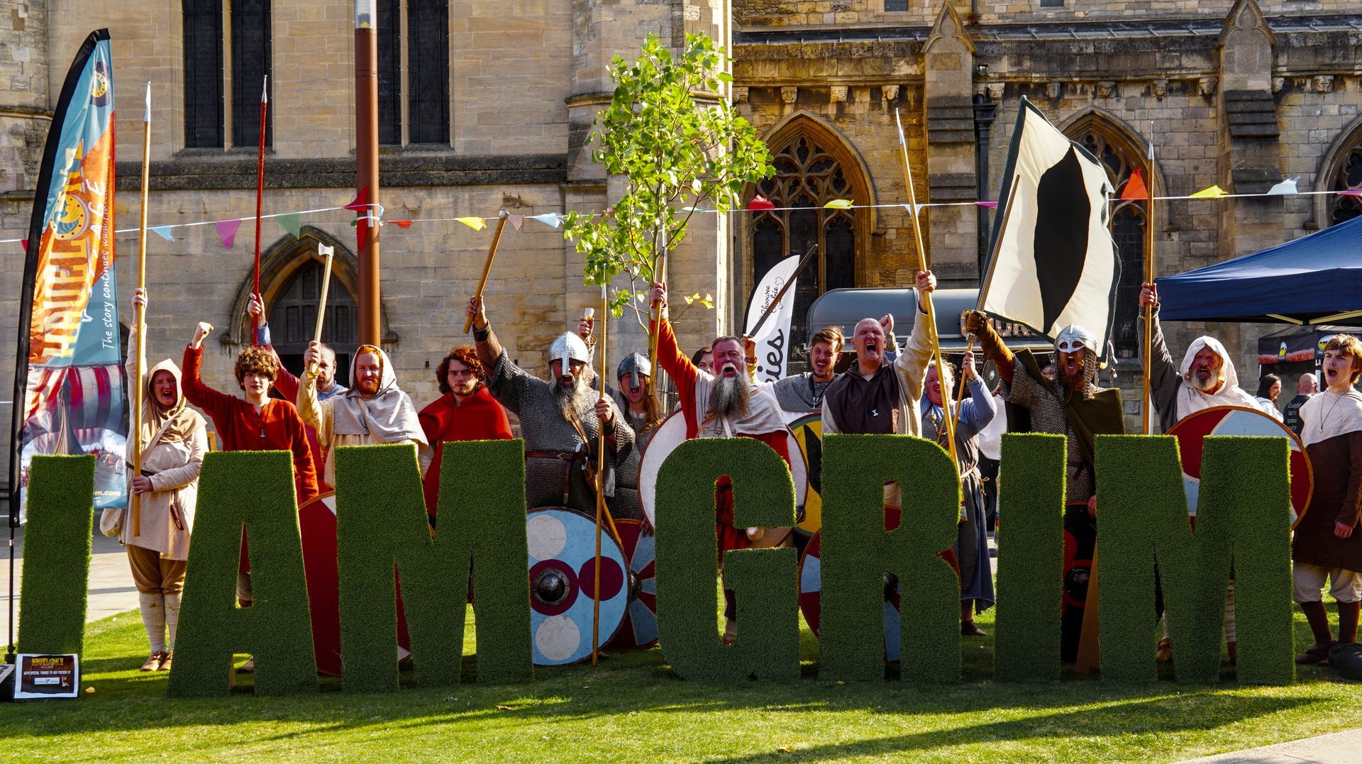 A group of people are standing in front of a sign that says tamworth.