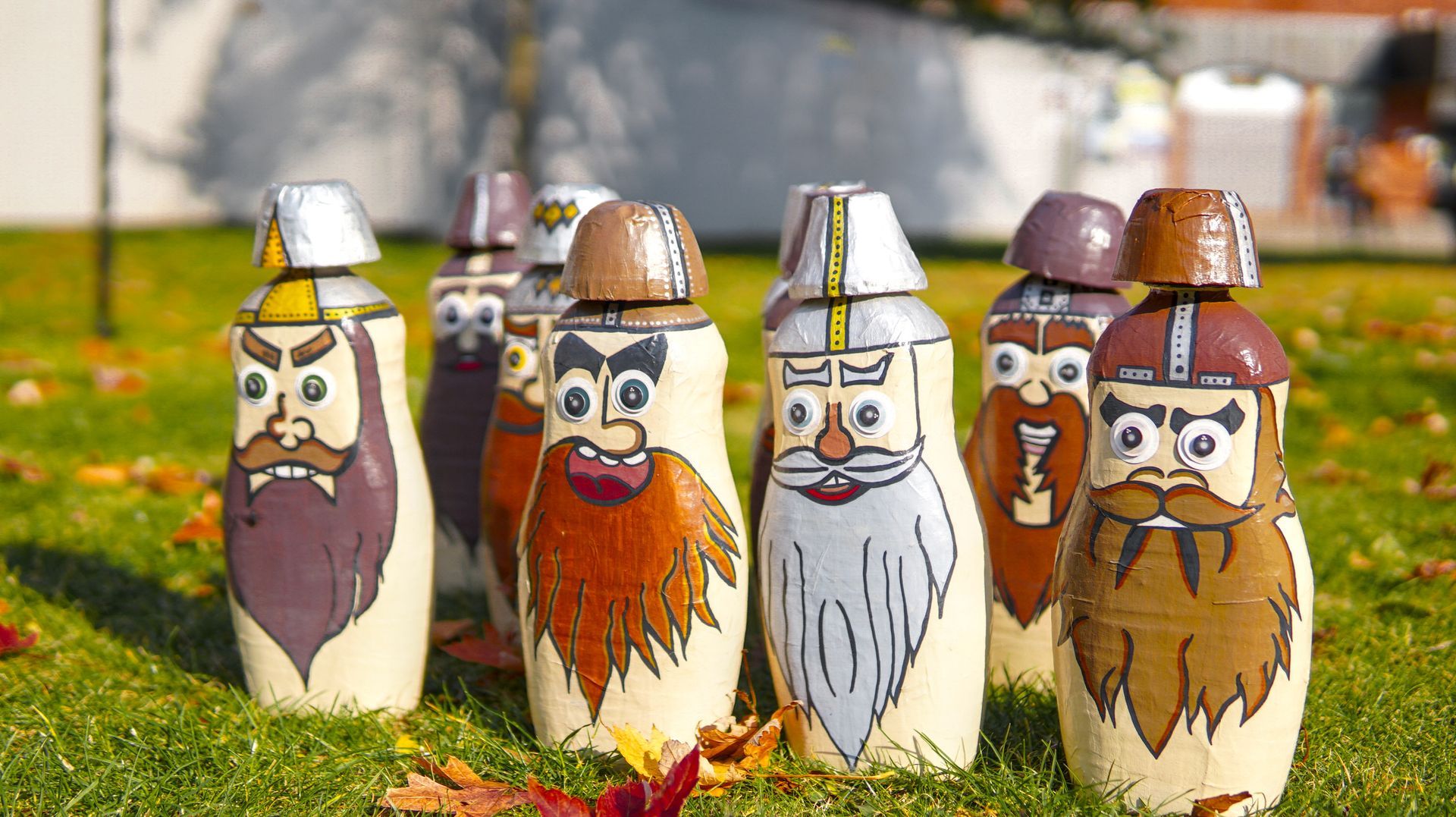 A bunch of bowling pins with bearded faces on them
