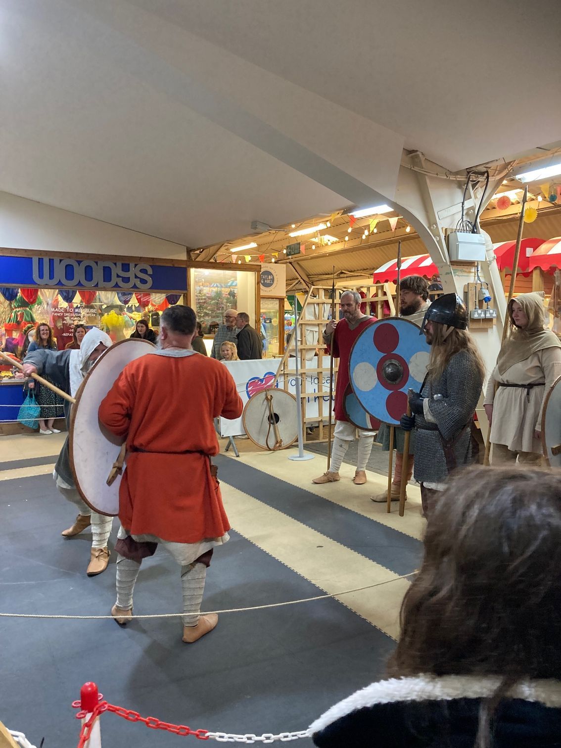 A group of people are standing in front of a woodes store