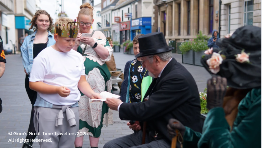 Boy wearing Havelok crown meets George Doughty and Eugania Doughty in Grim's Great Time Travellers
