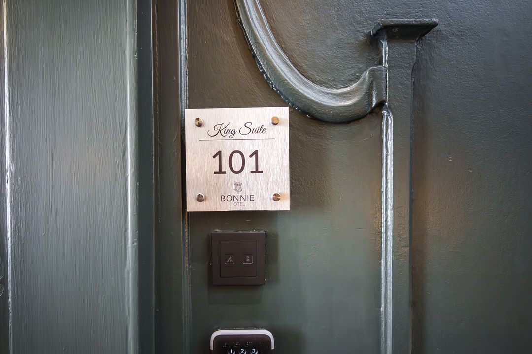 Door with a room number sign that reads 