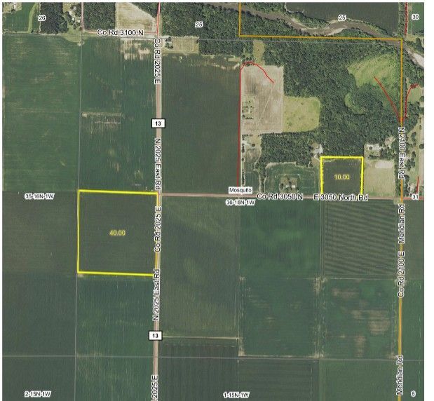 Satellite map with yellow outlined property parcels beside a road and wooded farmland