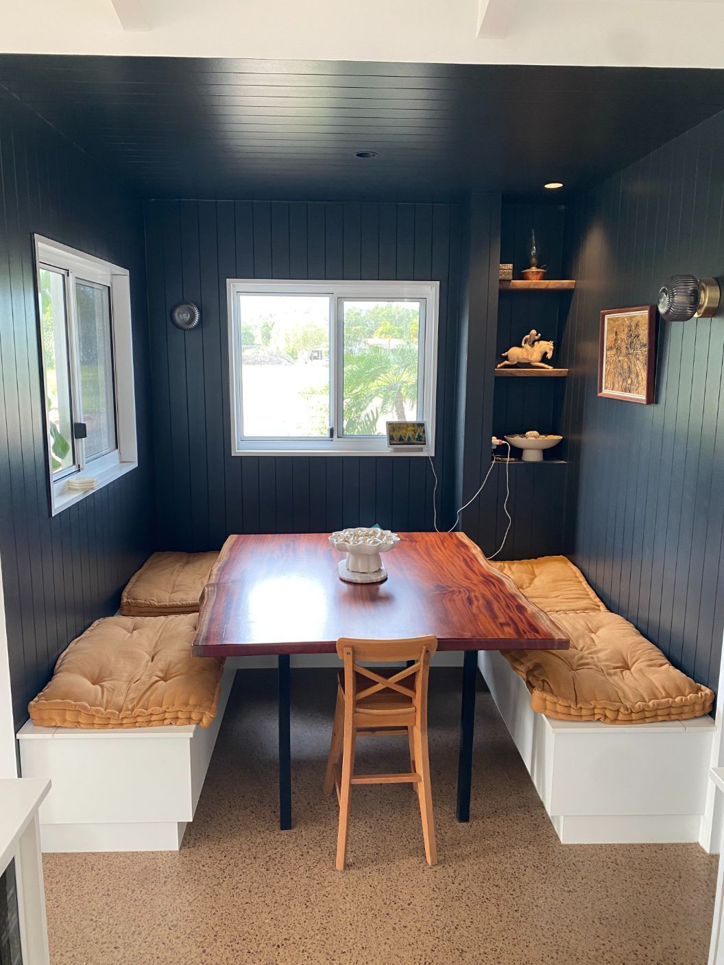 A dining room with a table and chairs and a window — Local Builders in Yarrawonga, NT