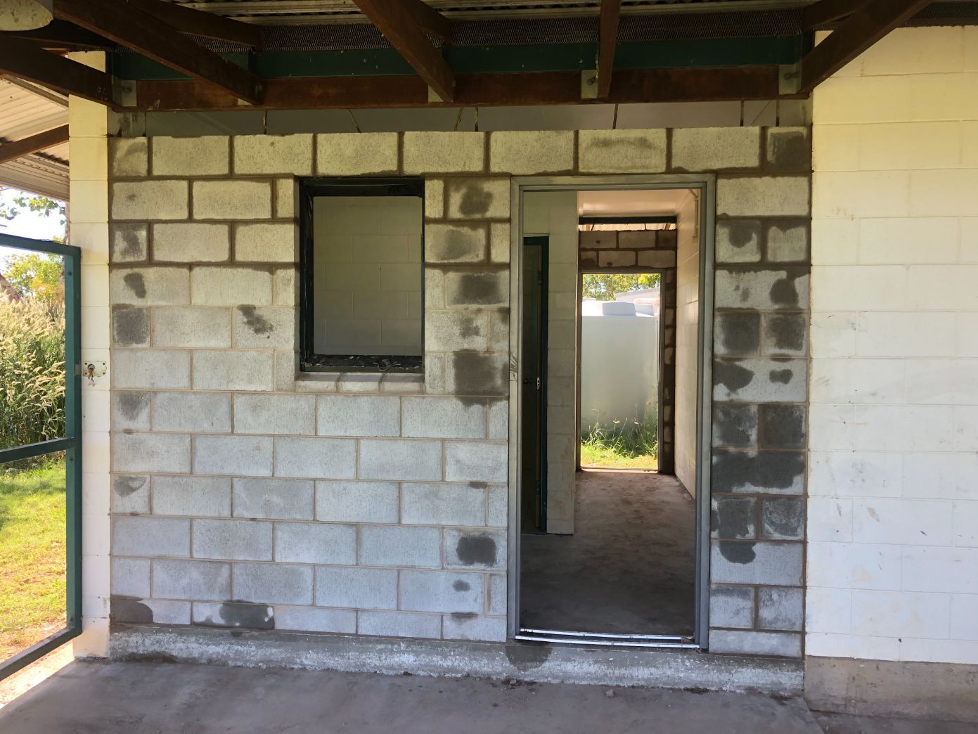 A brick wall with a window and a door — Local Builders in Yarrawonga, NT