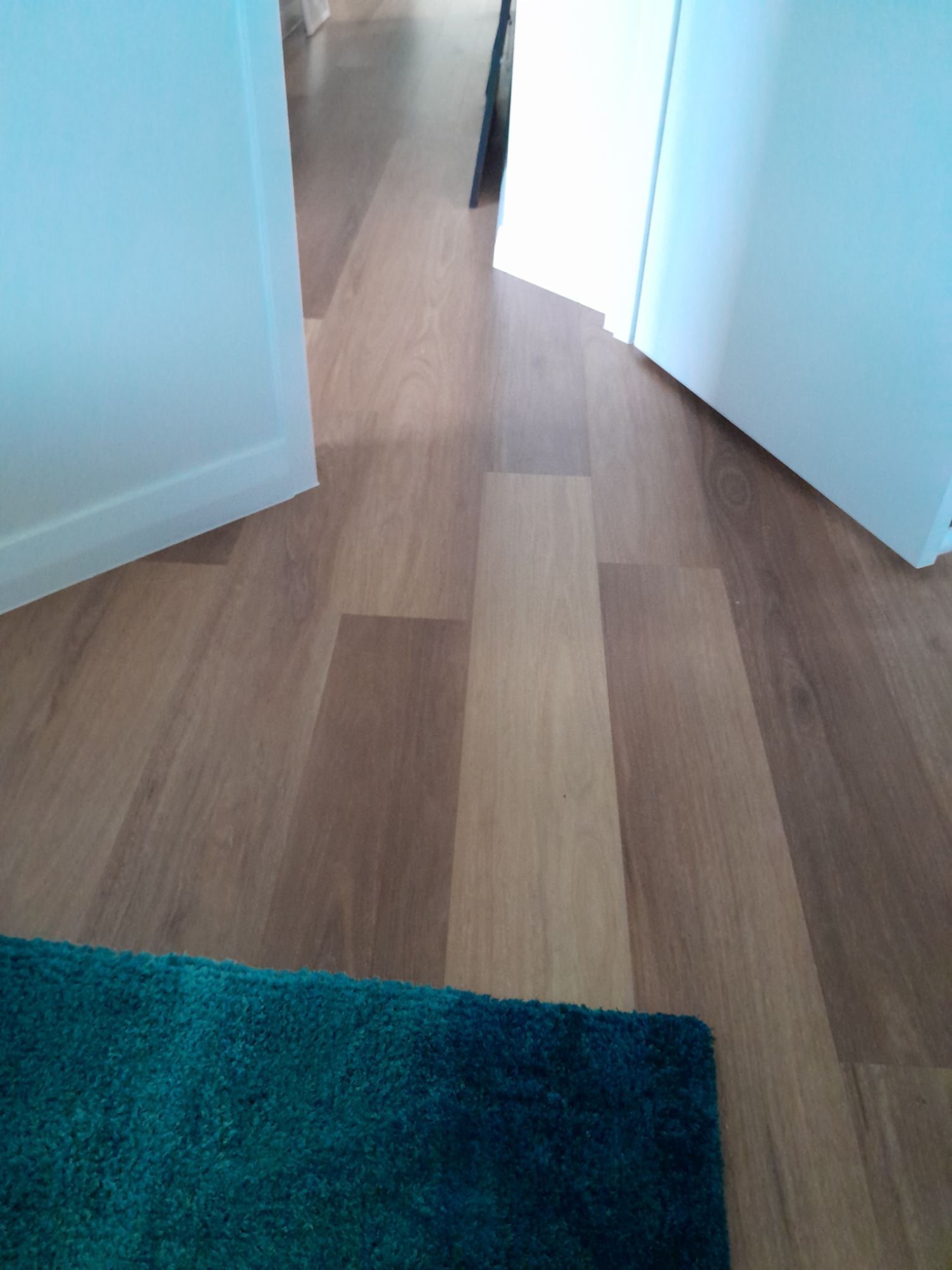 A wooden floor with a green rug on it — Local Builders in Yarrawonga, NT