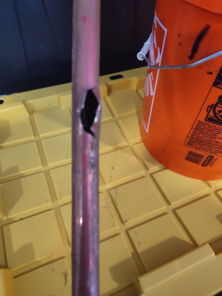 An orange bucket with a lightning bolt on it