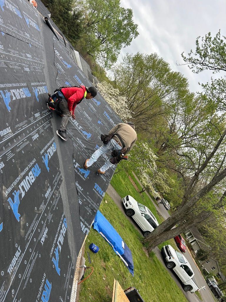 A group of people are working on a roof.