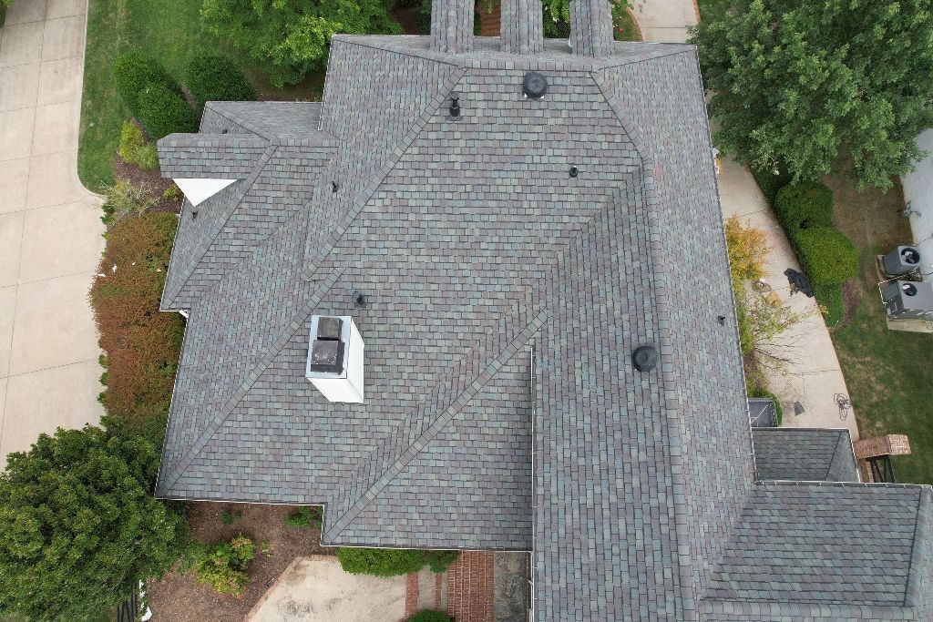 An aerial view of a large house with a gray roof.