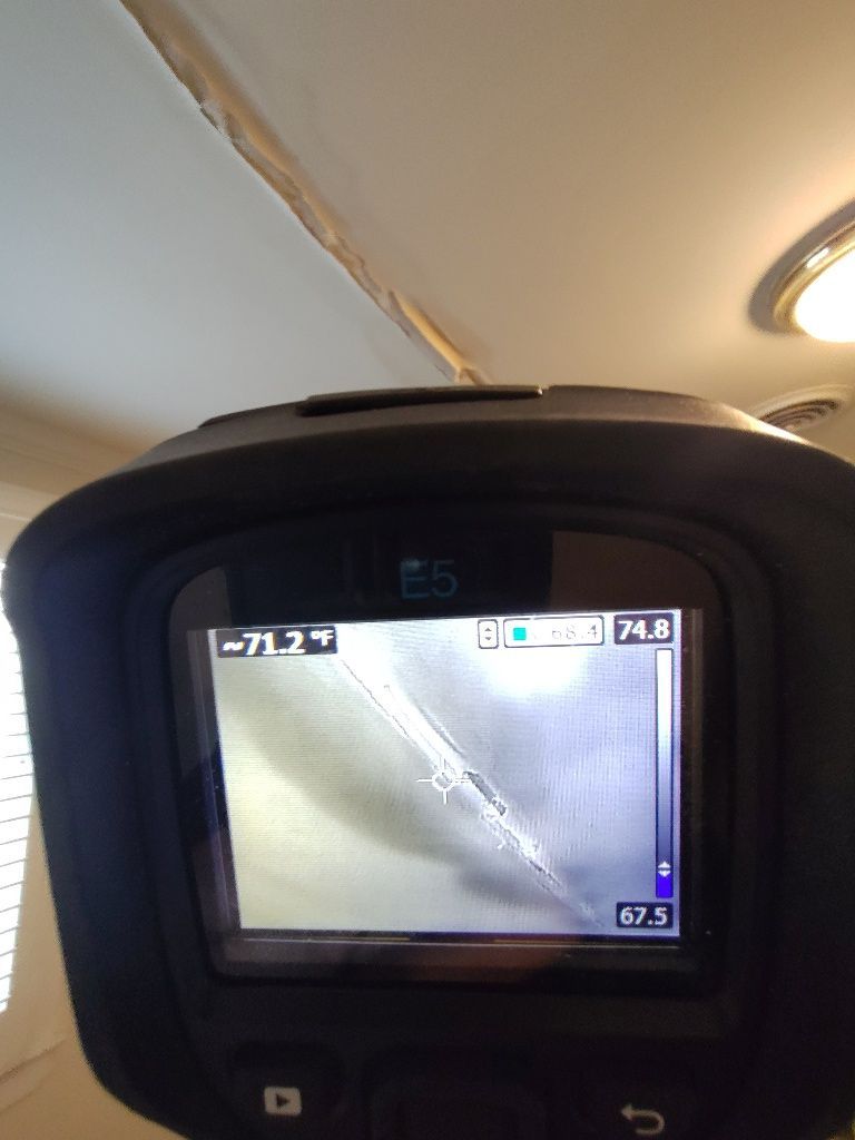 A thermometer is being used to measure the temperature of a room.